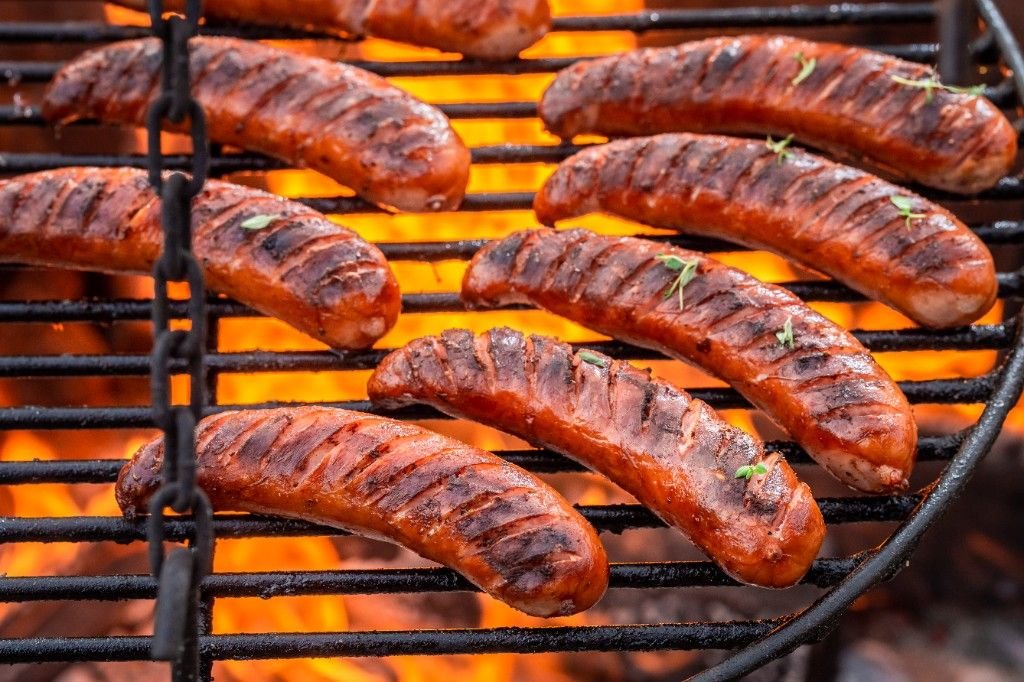 Sausages cooking on a barbecue grill